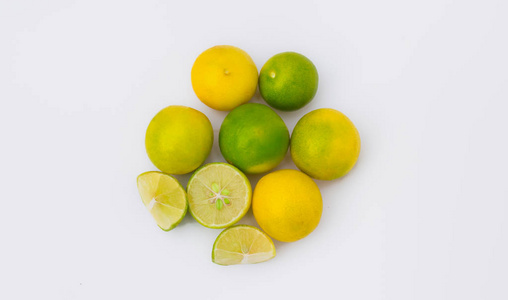 close up of six green and yellow lemon with slices 