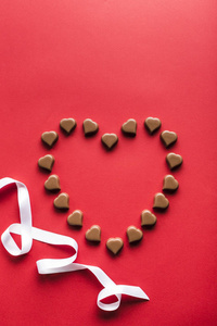 Heart shaped chocolates on red background for Valentines day 