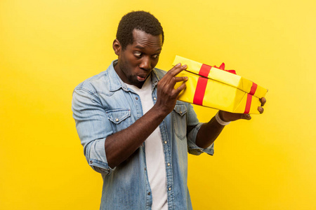 Longawaited interesting gift Portrait of amazed man unpacking 