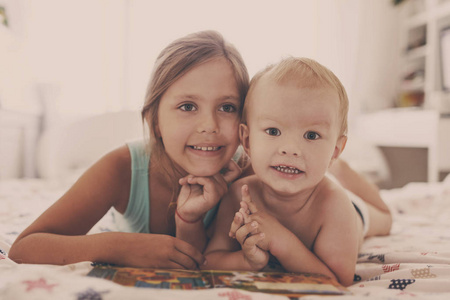 Two children reading a book  