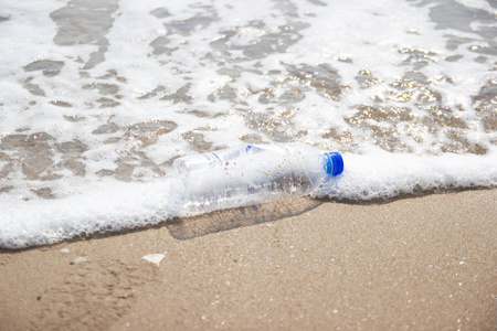 garbage and plastic bottles and dirty waste on a beach, 