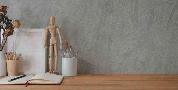 Cropped shot of trendy workplace with  supplies on wooden 