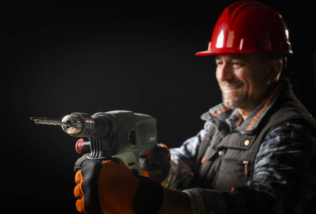 戴电钻的男工照片