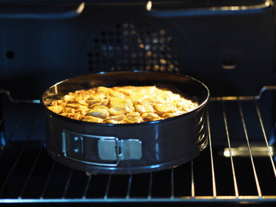 自制馅饼的面团在烤箱里用烤盘烘烤。