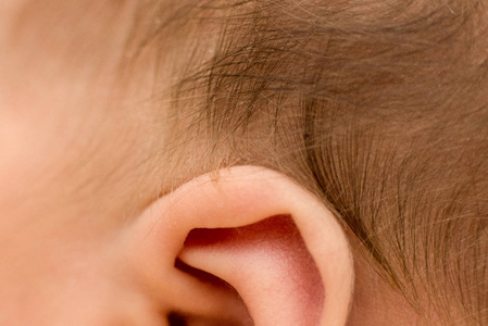 ear and hair of the newborn baby, macro, close up, maternal care