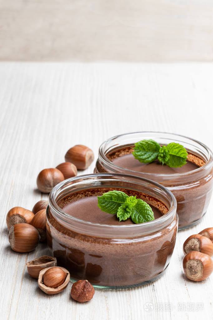 homemadechocolatehazelnutpralineinglassjarisolatedonwhi