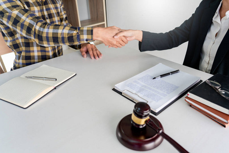 lawyer or attorneys shaking hand with client after consultation 