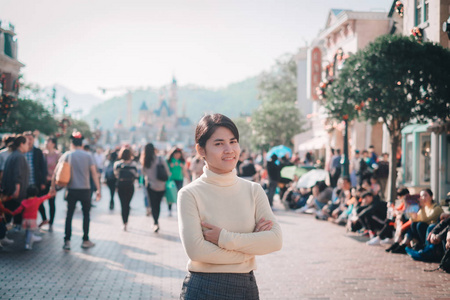 young woman traveling in Hong Kong Disneyland during winter and 