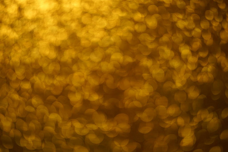 金色闪亮的模糊背景和圆形的闪光。