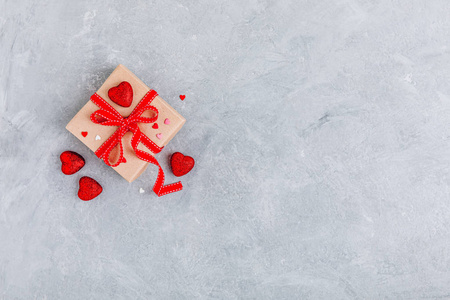 Valentine Day background with red hearts and a gift box with red