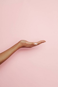 Empty woman hand on pink background. Woman hand presenting