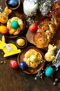 Easter holiday table. Easter cakes and colored eggs on a wooden 