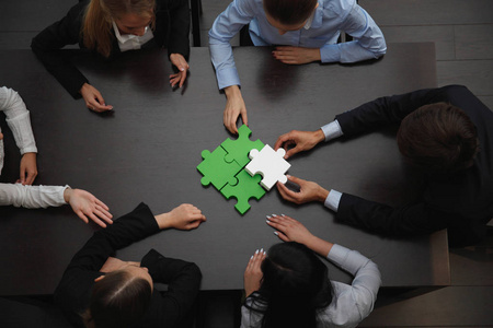 Business people assembling puzzle 