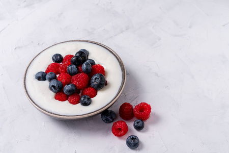 Tasty fresh blueberry raspberries yoghurt shake dessert in ceram