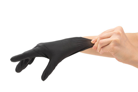 Woman puts on black rubber gloves. 