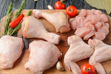 肉鸡鸡和蔬菜桌上的生鸡肉和蔬菜照片