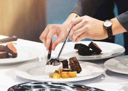 Decorate food serving dishes to the table in the restaurant  