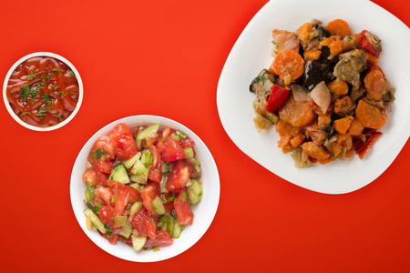 vegetable stew on a white plate. stewed vegetables on a colored 