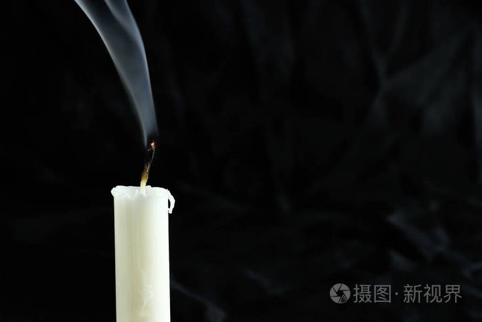 黑色背景上有烟的熄灭的蜡烛为文本复制空间