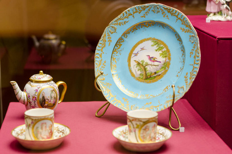 木制桌子上的一套古董陶瓷茶壶杯子茶碟。