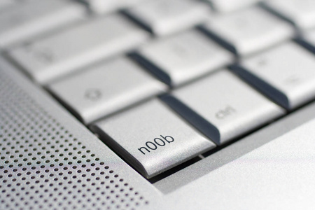 Close up shot of a laptop keyboard with a nOOb key in focus.