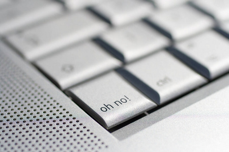 Close up shot of a laptop keyboard with an oh no key in focus