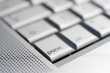 Close up shot of a laptop keyboard with a panic key in focus.