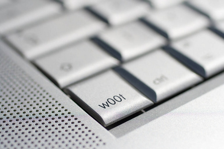 Close up shot of a laptop keyboard with a wOOt key in focus.