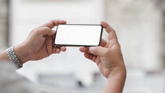 Cropped shot of  businessman holding horizontal blank screen sma