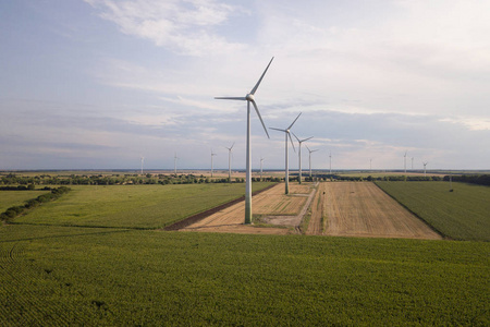 Aerial view of wind turbine generators in field producing clean 