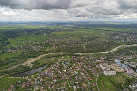 Aerial view of town or village with rows of buildings and curvy 