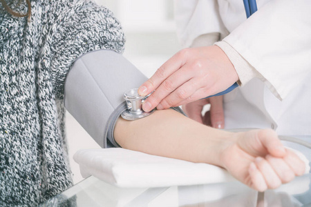 Doctor measuring blood pressure 