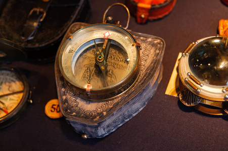  Many vintage compasses in showcase of the shop