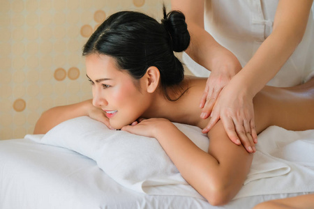 Asia beautiful woman during massage with essential oil in room 