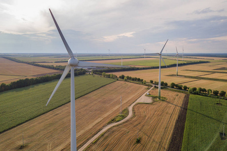 Aerial view of wind turbine generators in field producing clean 