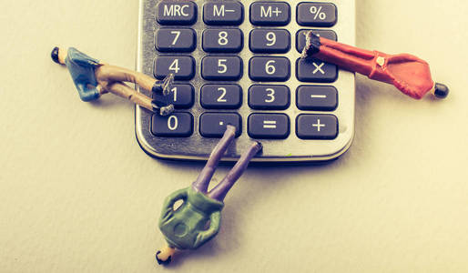Men figurine on Calculator device  with a keyboard 