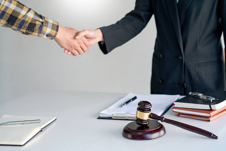 lawyer or attorneys shaking hand with client after consultation 