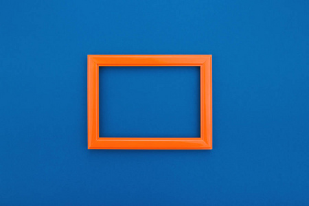 Empty orange frame on the classic blue background. Trendy greeti