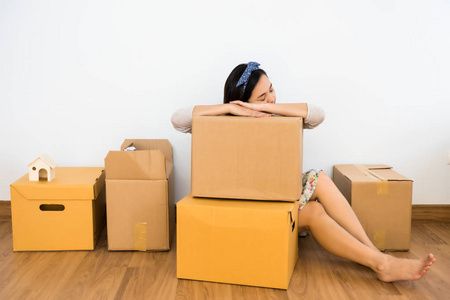 TIred woman sleep on moving box 