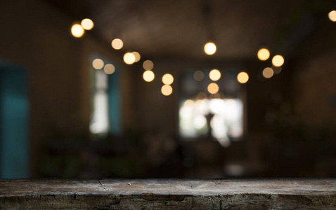 Empty wood table top on blur light gold bokeh of cafe restaurant