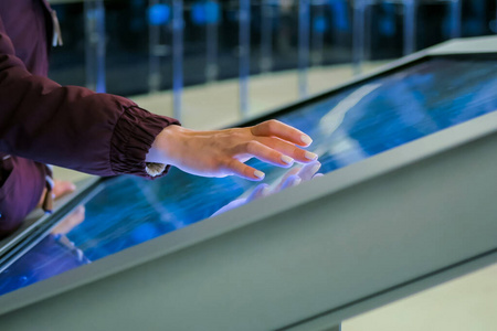 触摸互动科技展上使用互动触摸屏的女性照片