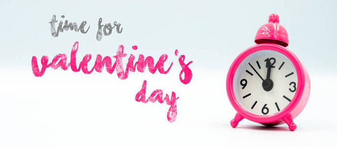 Time for valentines day inscription near a pink clock on a wh