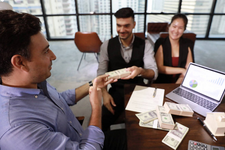 Caucasian business man and asian business woman received money a