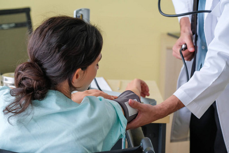 The doctor performed blood pressure measurement for female 