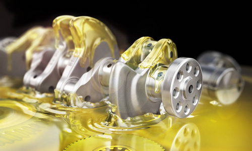 润滑油概念.曲轴上的油在黑色模糊不清的背上照片