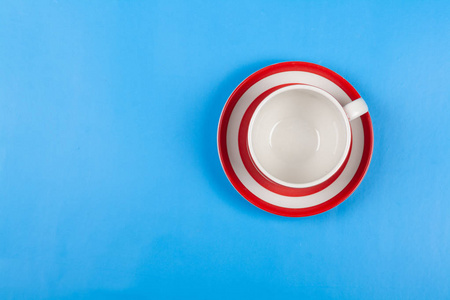 Empty cup for tea on a blue background Top view