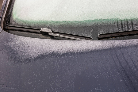 First thin layer of snow on cars in the morning. Winter season, 