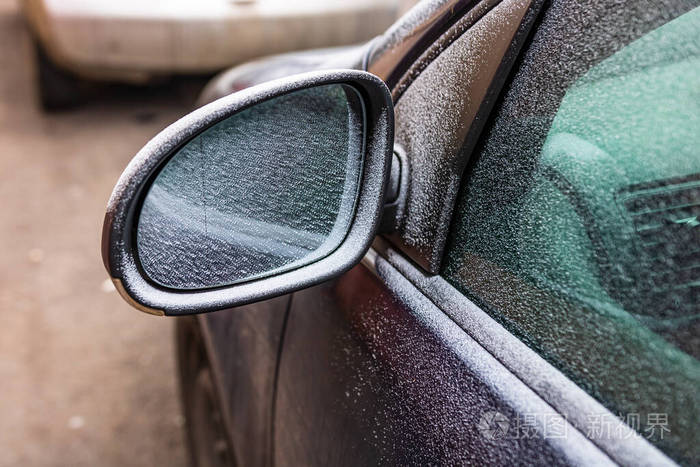 First thin layer of snow on cars in the morning. Winter season, 