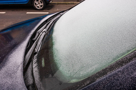 First thin layer of snow on cars in the morning. Winter season, 