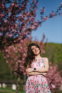 Elegant woman in beautiful dress stand outside. Gorgeous model w